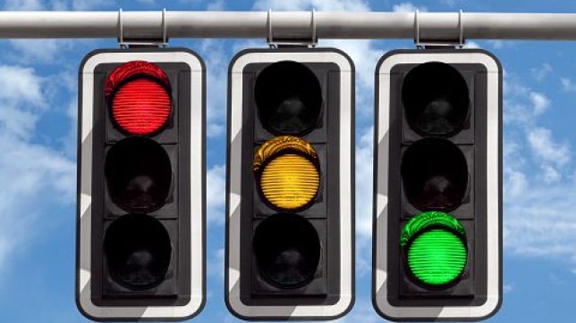 Traffic lights - red yellow green against sky