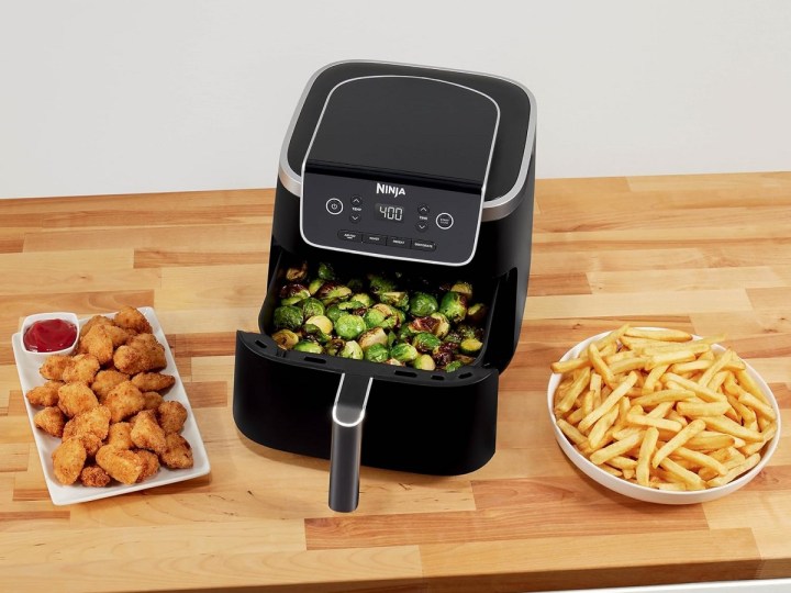 The Ninja Air Fryer Pro on a countertop with food.