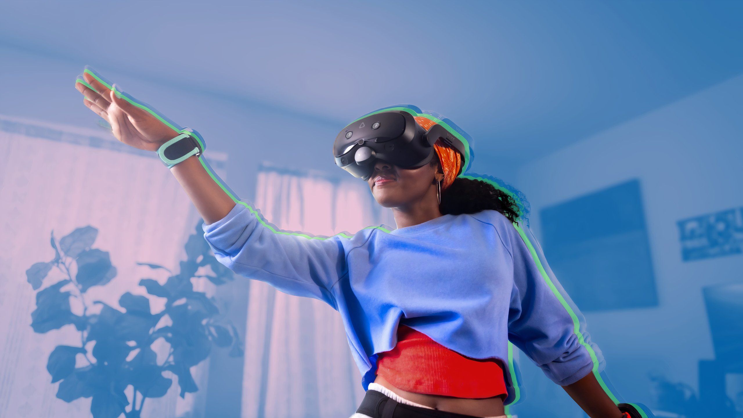 A woman wearing a Vive Focus Vision headset and dancing with motion trackers trapped to her arms.