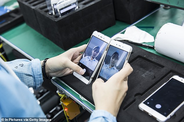 Employees and Smartphones seen on the assembly line at the OnePlus manufacturing facility in Dongguan, China