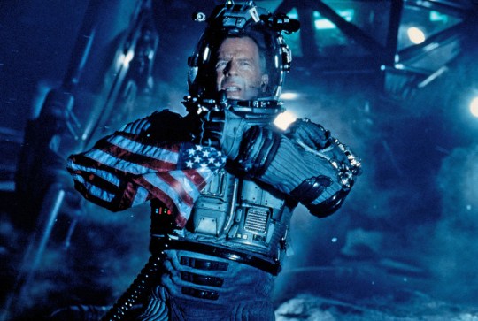 A screenshot from Armageddon showing Bruce Willis as Harry Stamper in a spacesuit