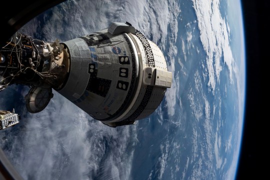 Boeing's Starliner spacecraft seen docked to the Harmony module of the International Space Station on July 3, 2024, seen from a window on the SpaceX Dragon Endeavour spacecraft docked to an adjacent 