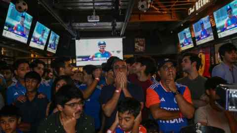 Fans in New Delhi react as they watch a live telecast of the ICC Men’s T20 World Cup final cricket match between India and South Africa in Barbados in June