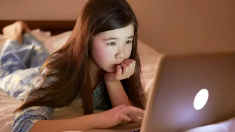 Getty Images A young girl using a computer