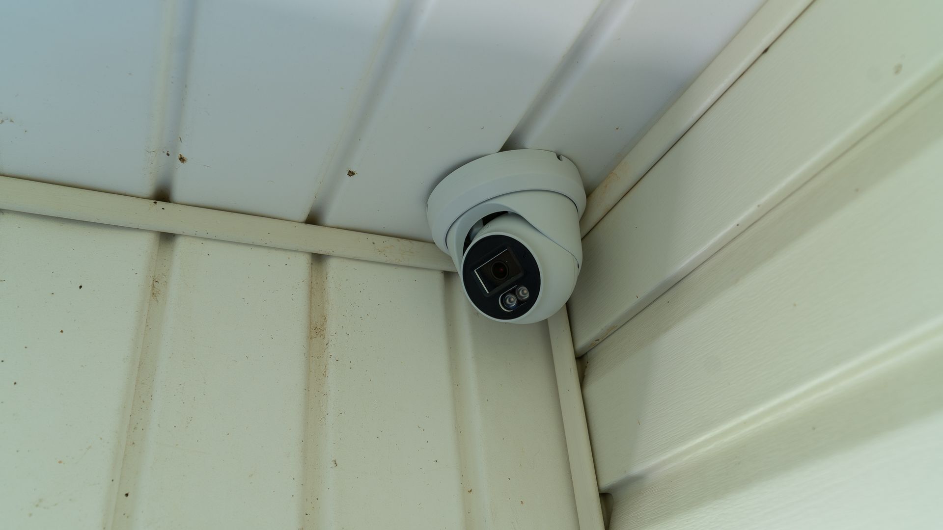 A PoE security camera mounted in the corner of a porch.