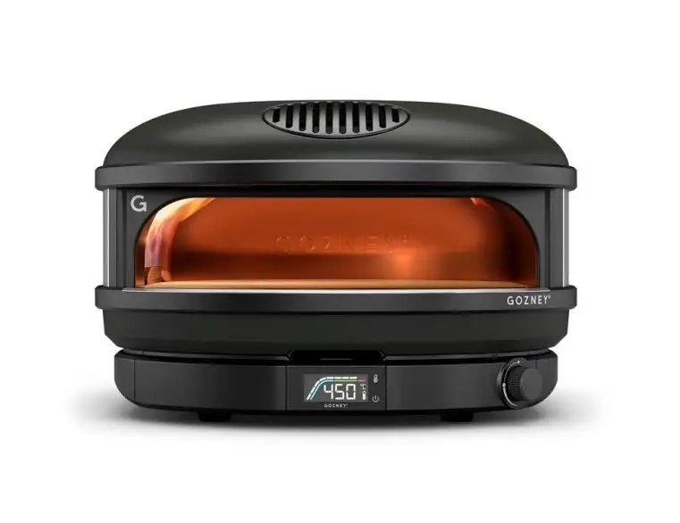 Sort Gozney Arc XL bordovn med digital temperaturvisning, cirkulær design og åben front med lysende orange interiør.