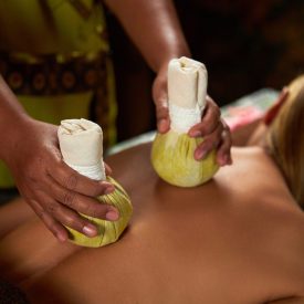 The master does back massage with Herbal bags, spa treatments, SPA ritual The master does back massage with special devices, spa treatments. High quality photo