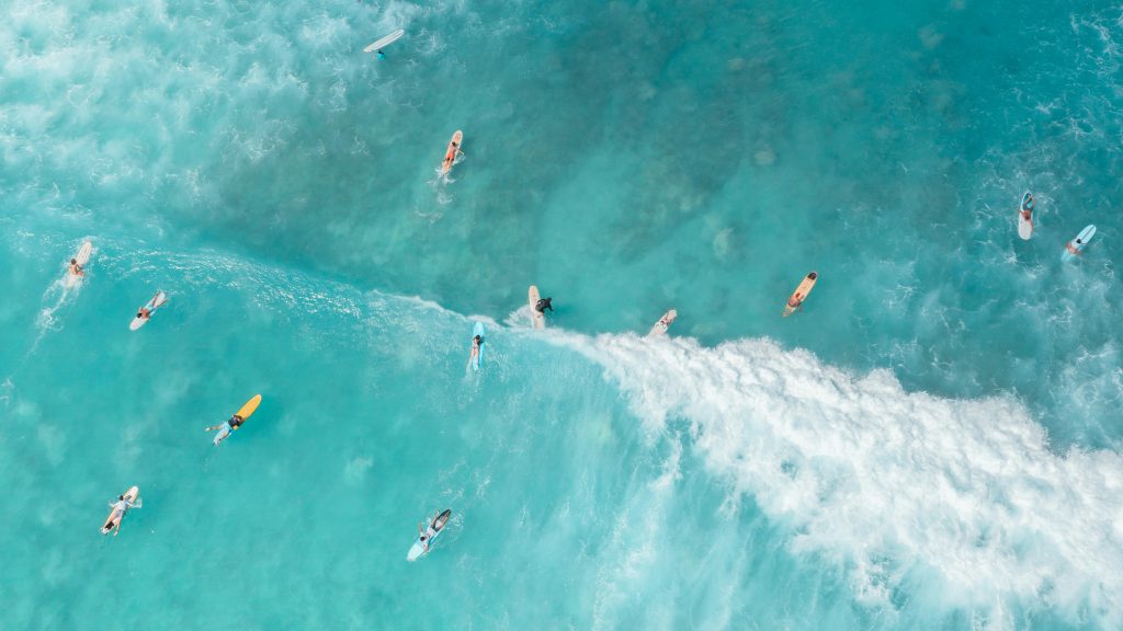 Surfers in the ocean. Drone footage.