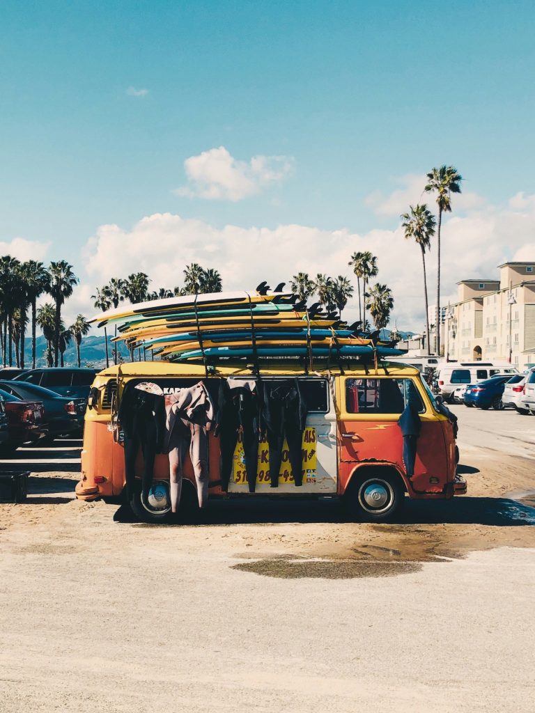 Wetsuits hanging on a van