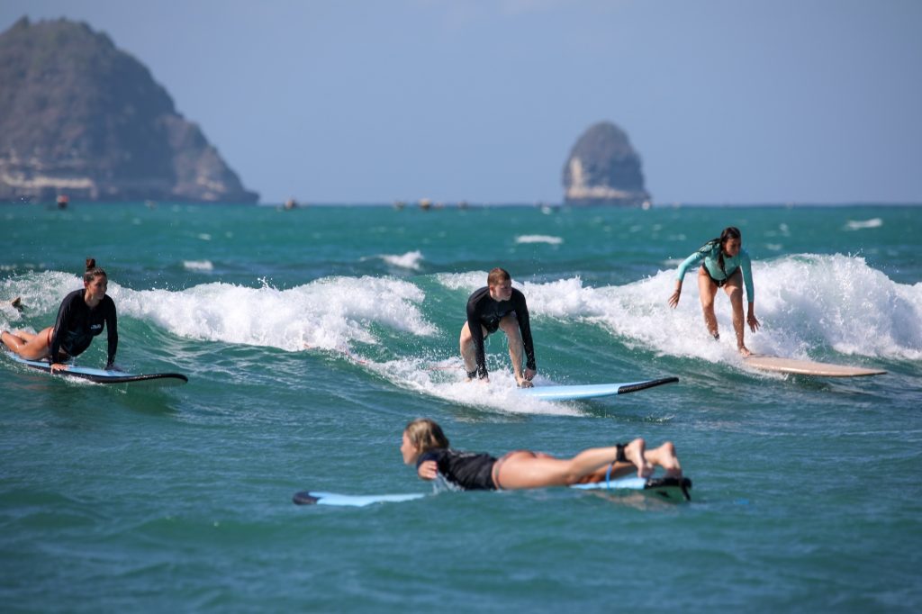 Beginners surfing in Lombok on the same wave