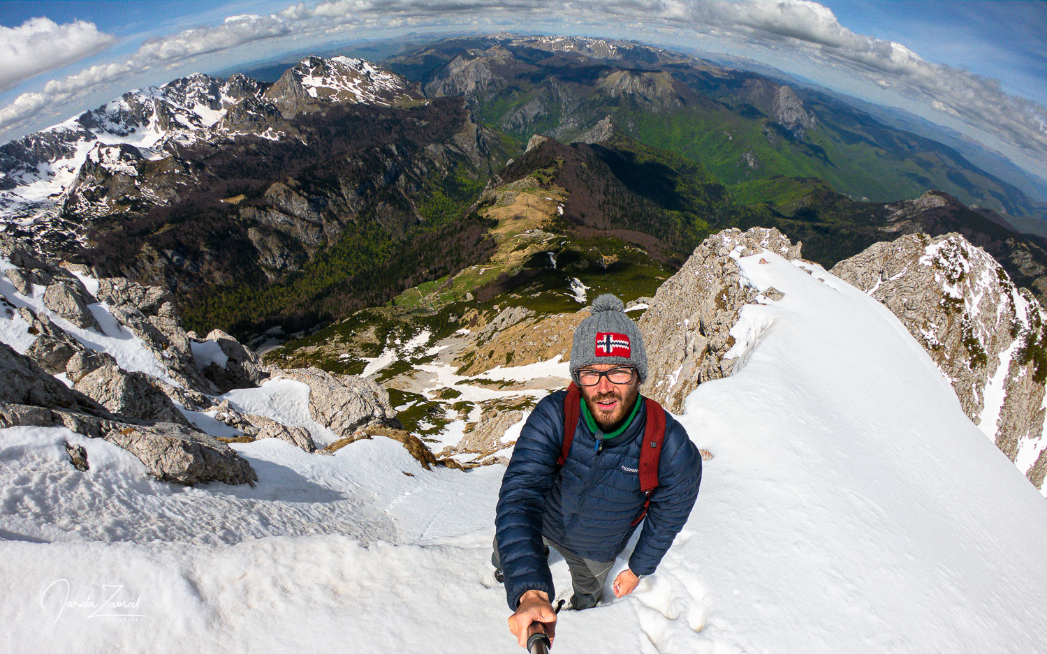 Snow on the mountain Maglić anda hiker on the final ridge