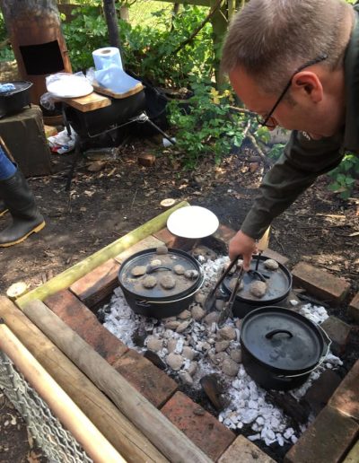 The Bushcraft Man cooking Hot Buns in a Dutch Oven