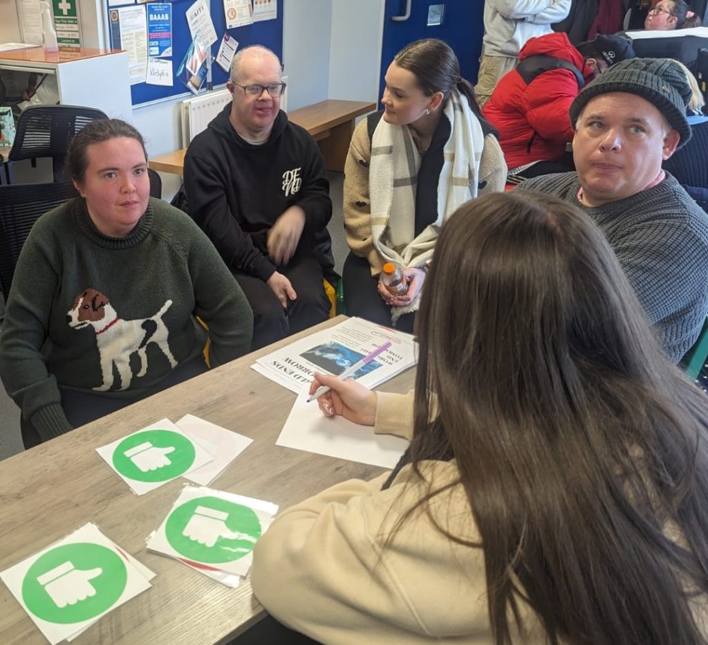 A photo of Orchardville service-users doing an activity around a table