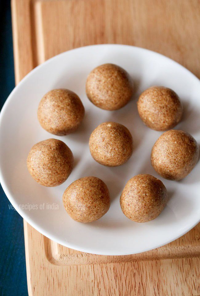 peanut ladoo served on a white plate with text layover. 