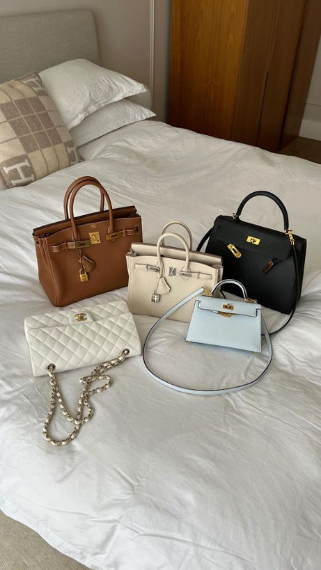 5 Designer Investments Bag laying on a bed