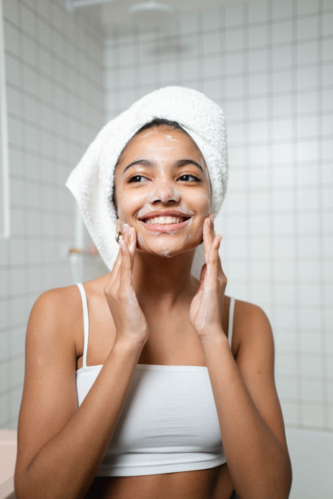 Woman applies affordable self-care skincare routine