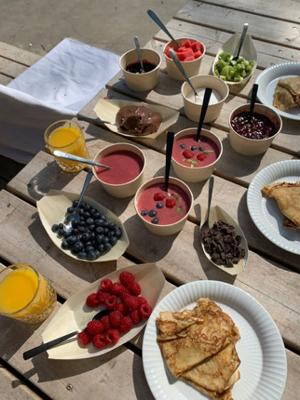 Perfect brunch table with pancakes, berries and smoothies