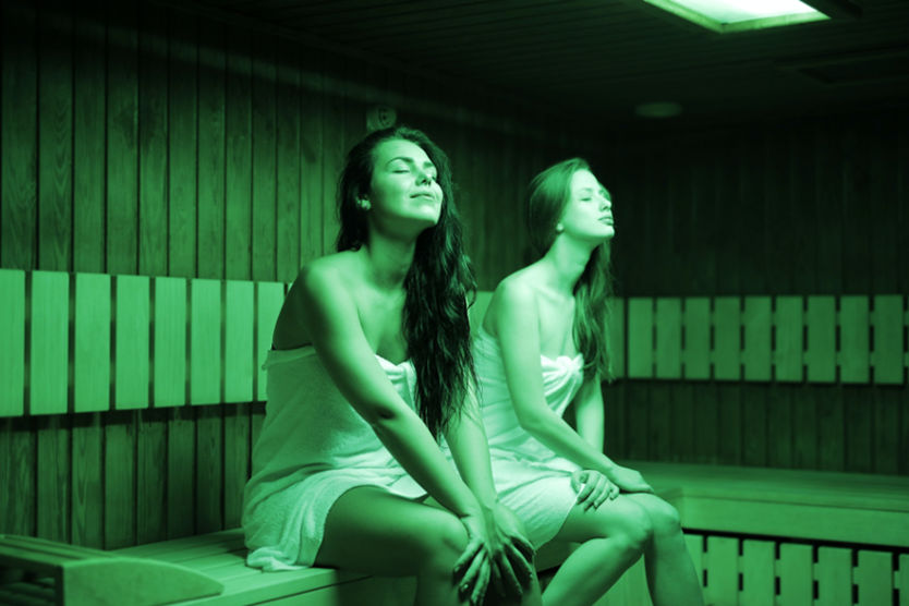 Women sitting in infrared sauna with light therapy