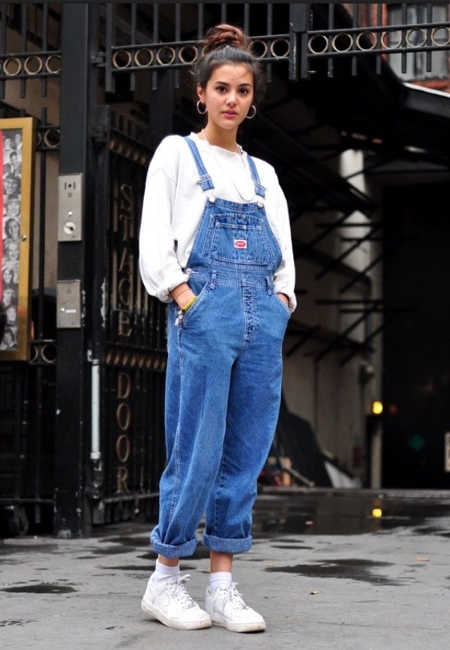 Woman wearing a sweater and overalls