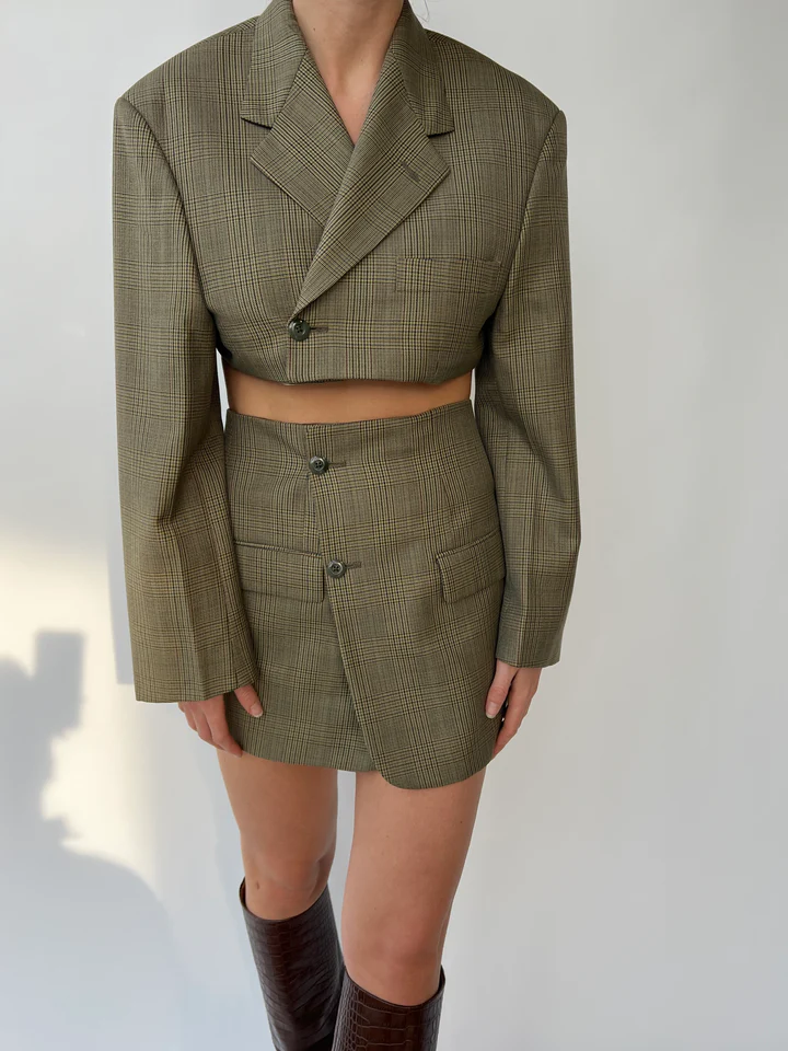 Woman wearing an ethical blazer and skirt set from the brand called Havre Studio