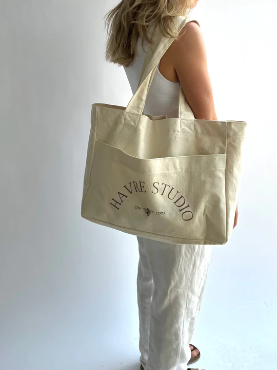 Woman wearing an ethical mule bag from the brand called Havre Studio