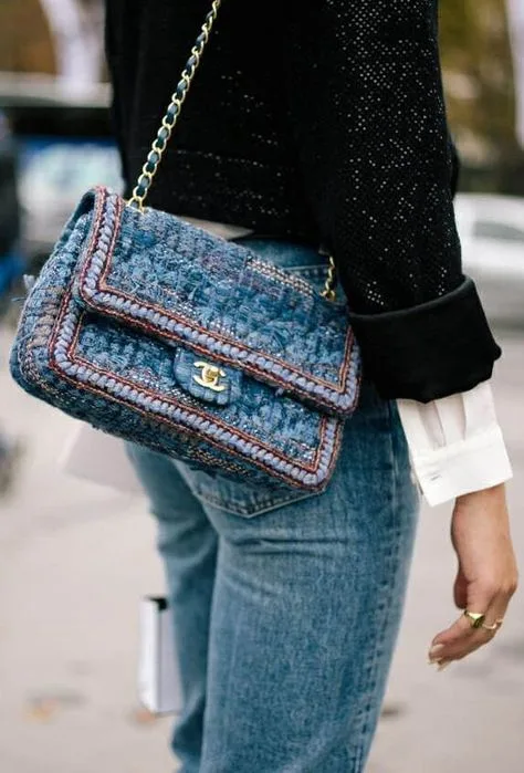 A chic blue denim Chanel waist bag, stylishly worn with a denim outfit, showcasing a relaxed yet fashionable look.