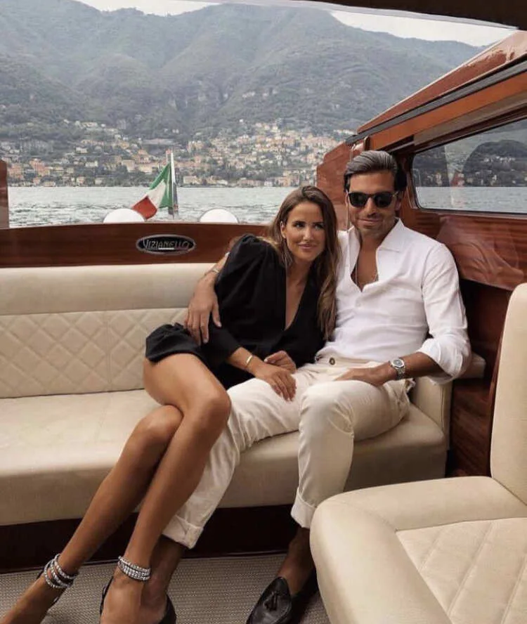 A old money fashion couple sitting on a yacht