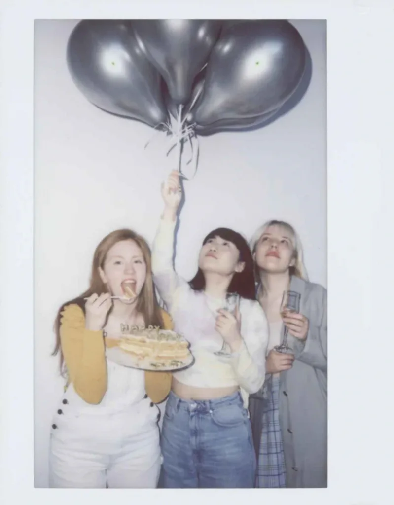 three-female-friends-eating-birthday-cake-expressing-happy-birthday-wishes