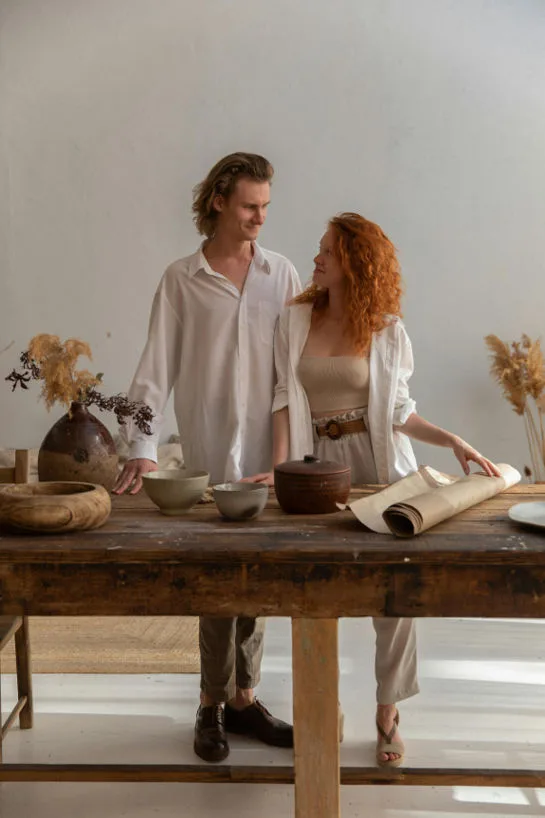 Couple Smiling standing at a DIY Home Decor table