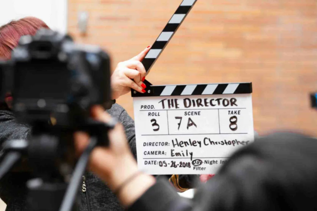 Picture showcasing a director's clapperboard to start filming a movie. Showcasing movies made into books.
