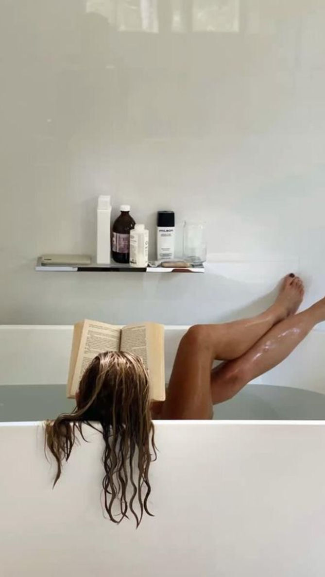 Girl reading in the bathtub