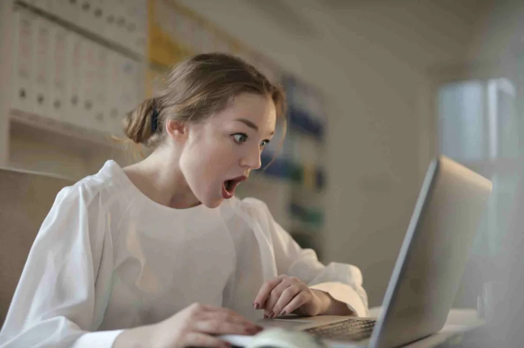 A woman shocked by watching something in the computer.