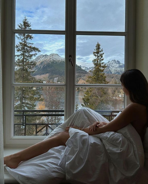 girl feeling down and sitting by the window