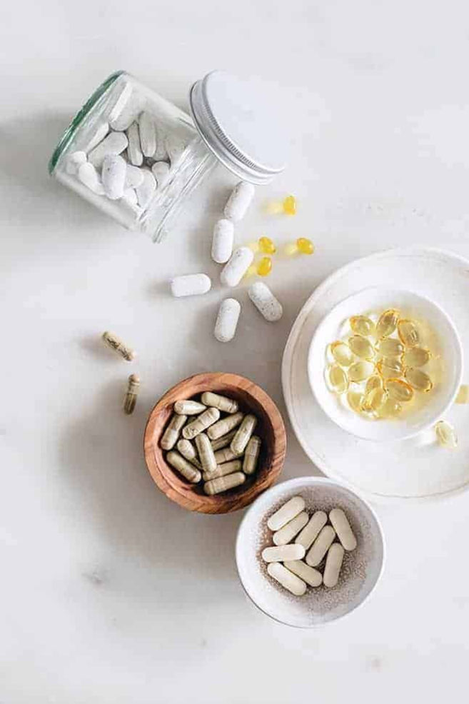 Vitamins and supplements in bowls and containers
