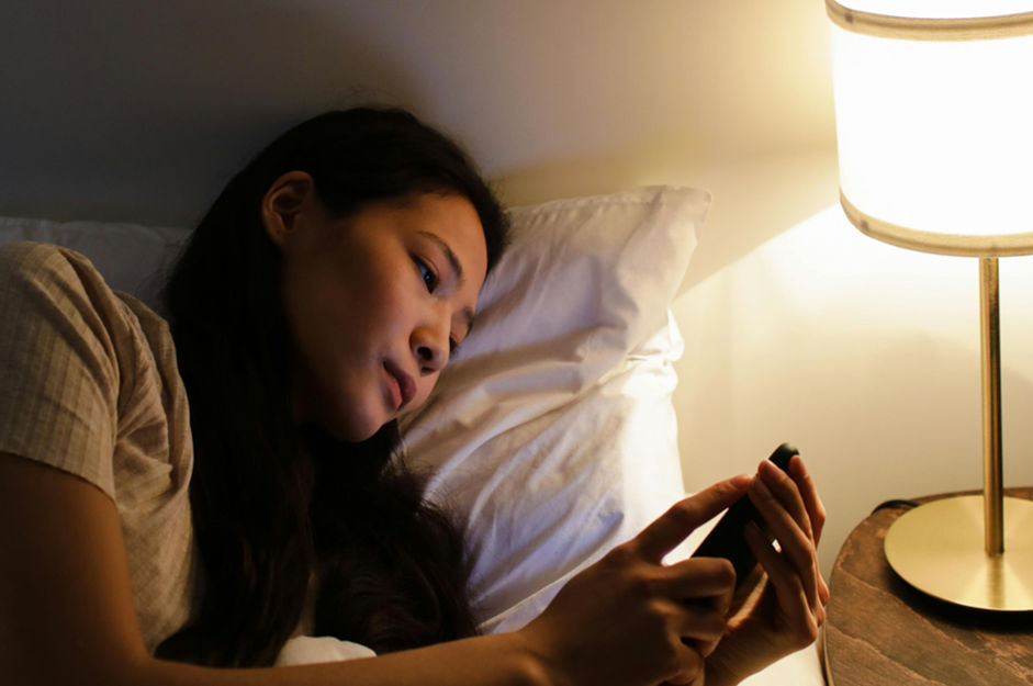 woman anxiously looking at her phone