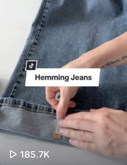 A woman on TikTok showing how to hem jeans for underconsumption core