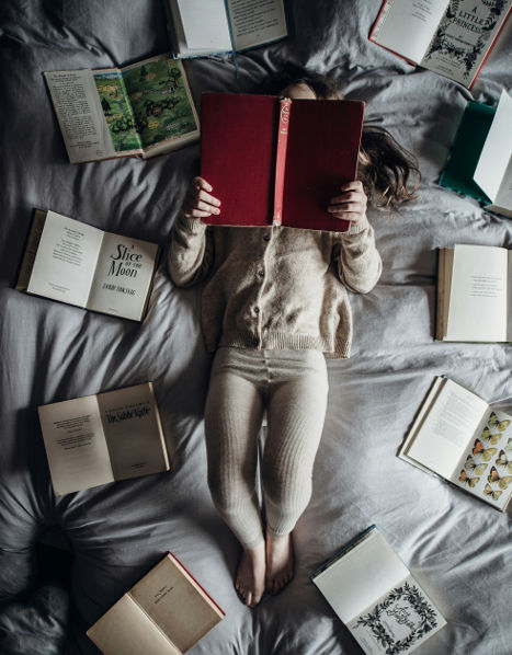 girl reading in bed