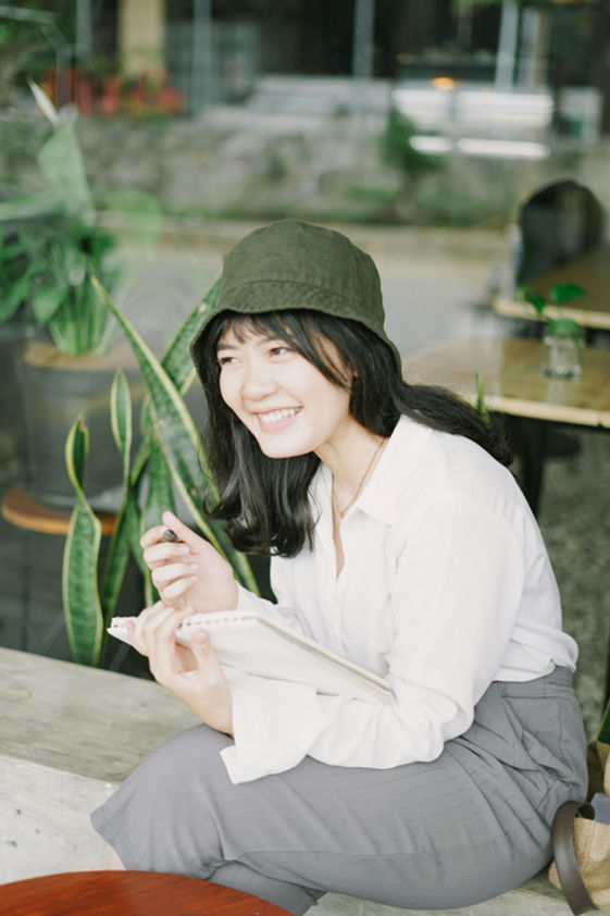 a woman smiling and journaling