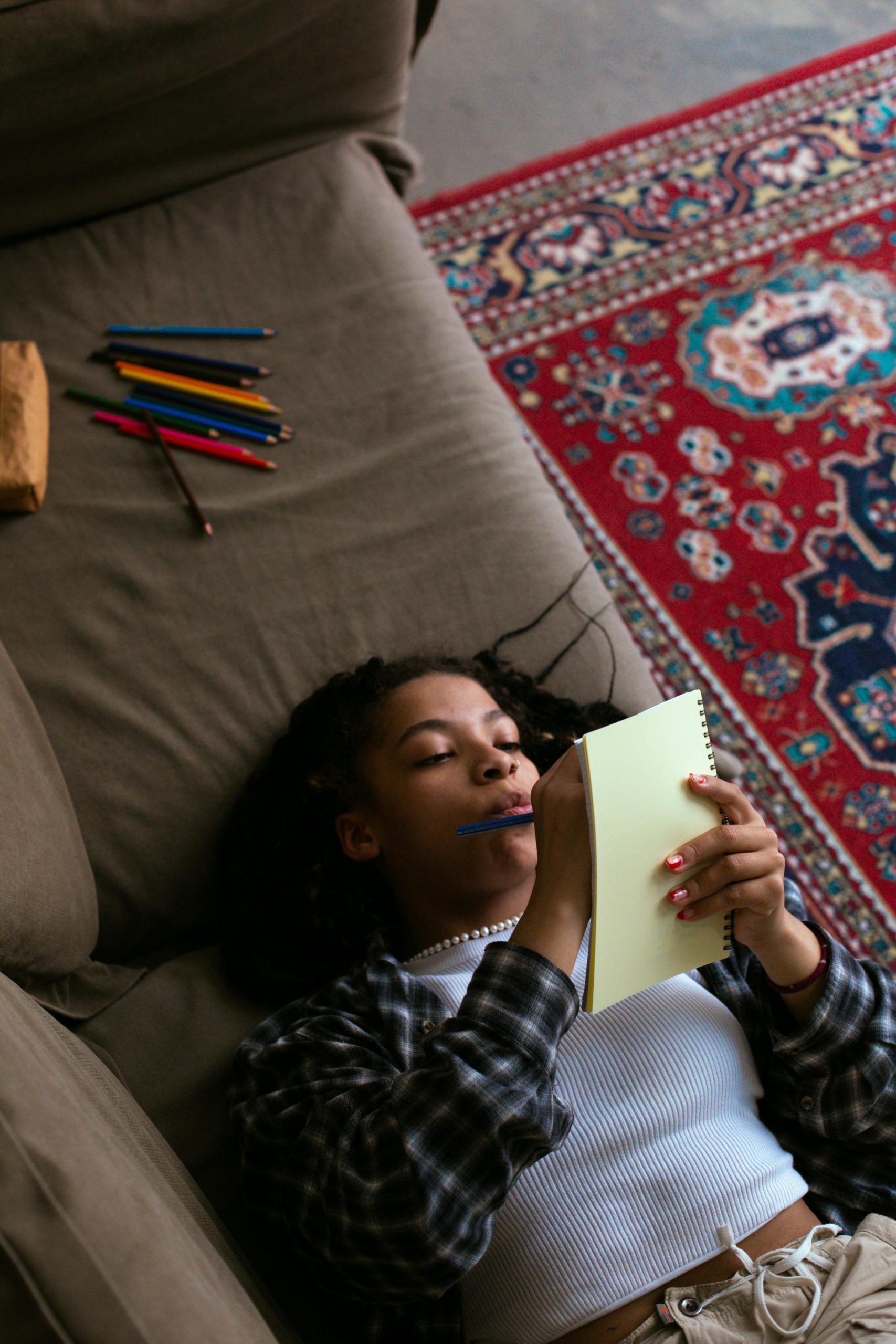  a girl writing in a notepad

