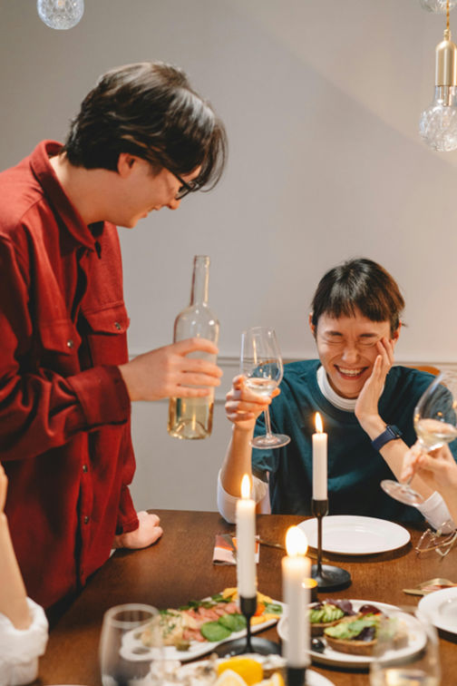 friends laughing at a dinner party
