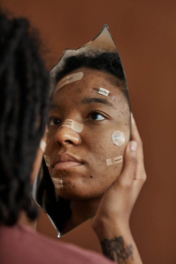 woman looking at herself in the mirror
