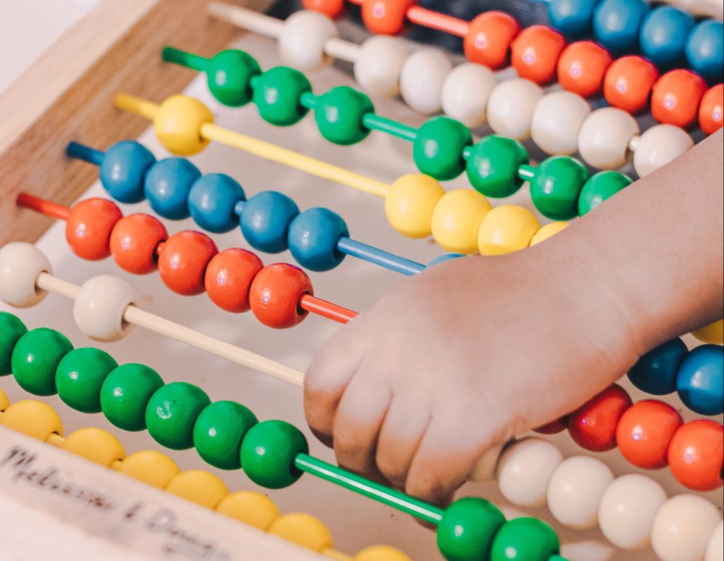 Close-up of young child playing with abacus