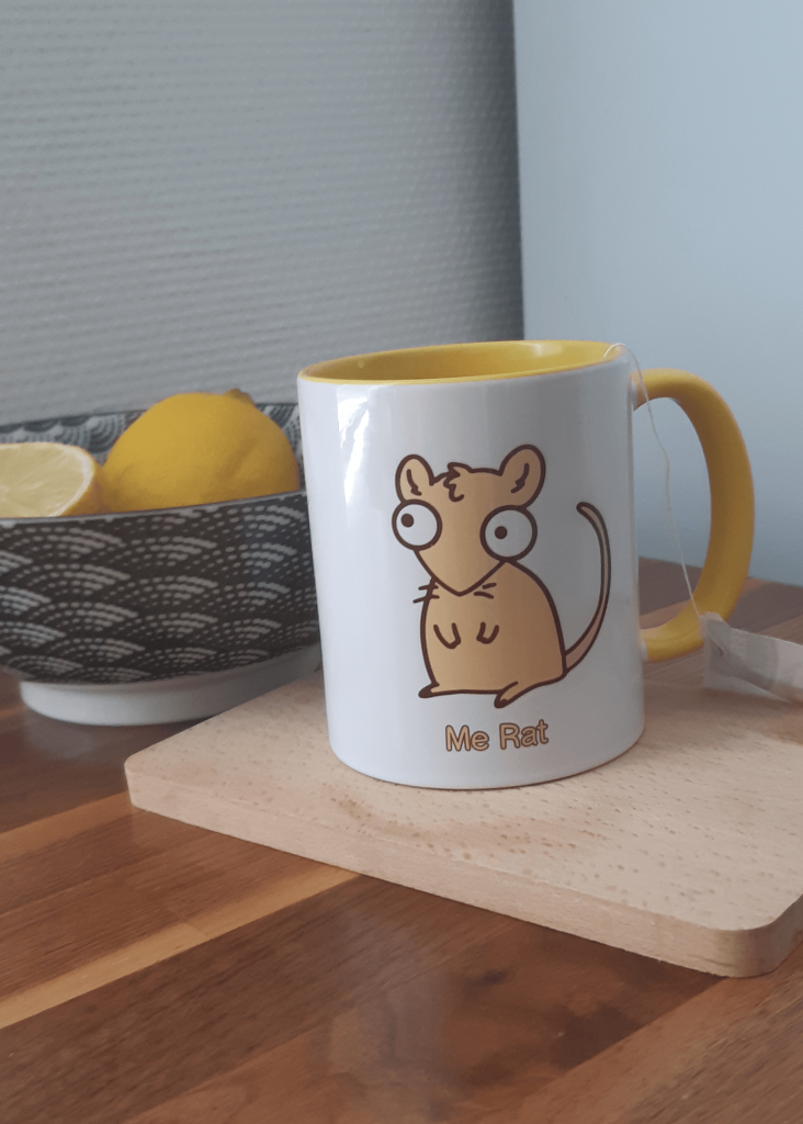 a cup with a drawn rat on