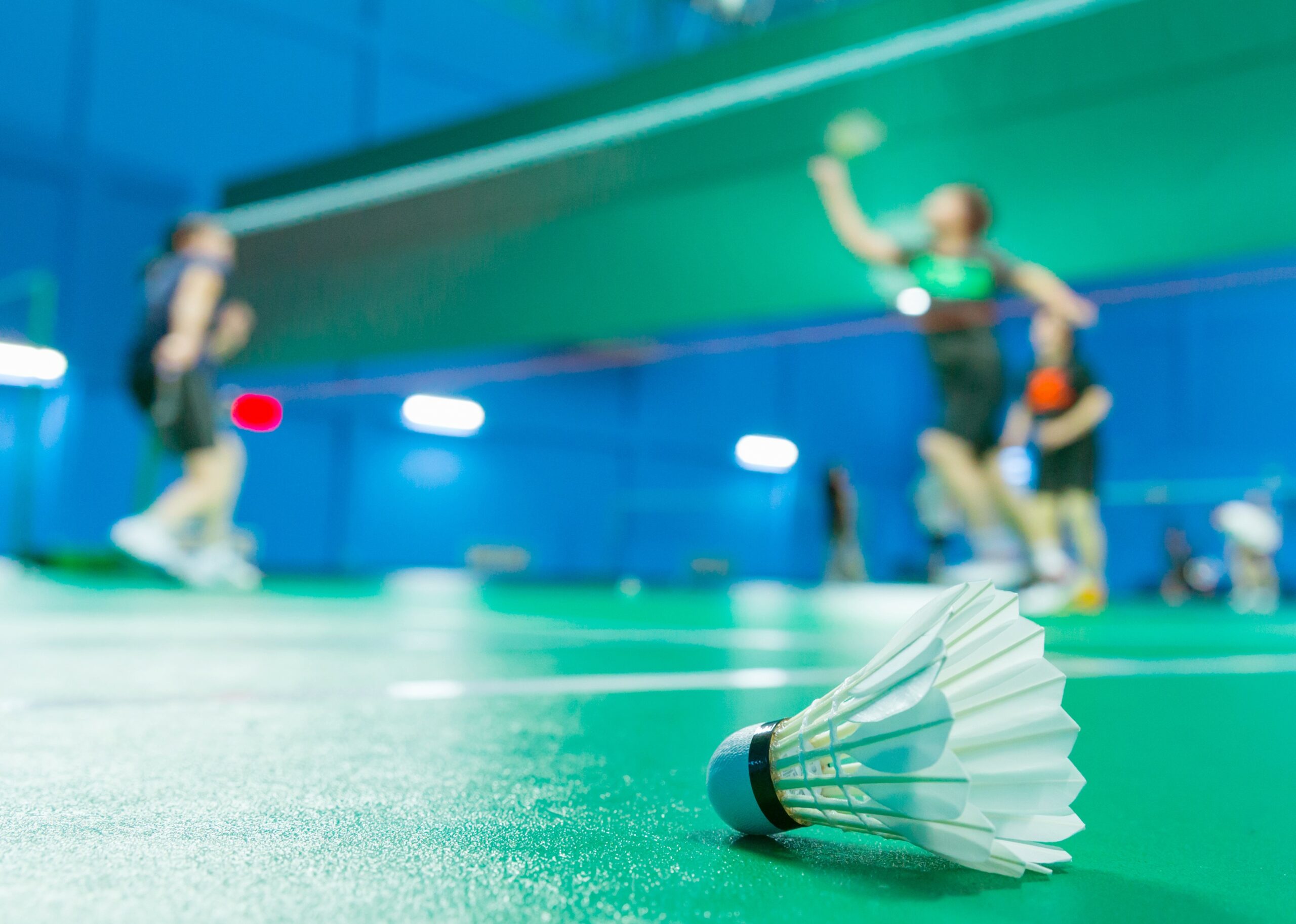 Badminton,Courts,With,Players,Competing