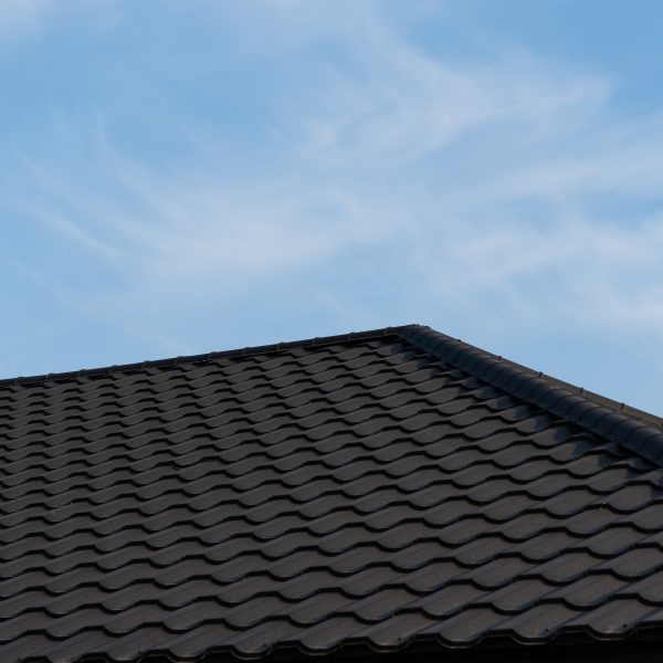 The roof features sleek new black metal tiles showcasing modern construction
