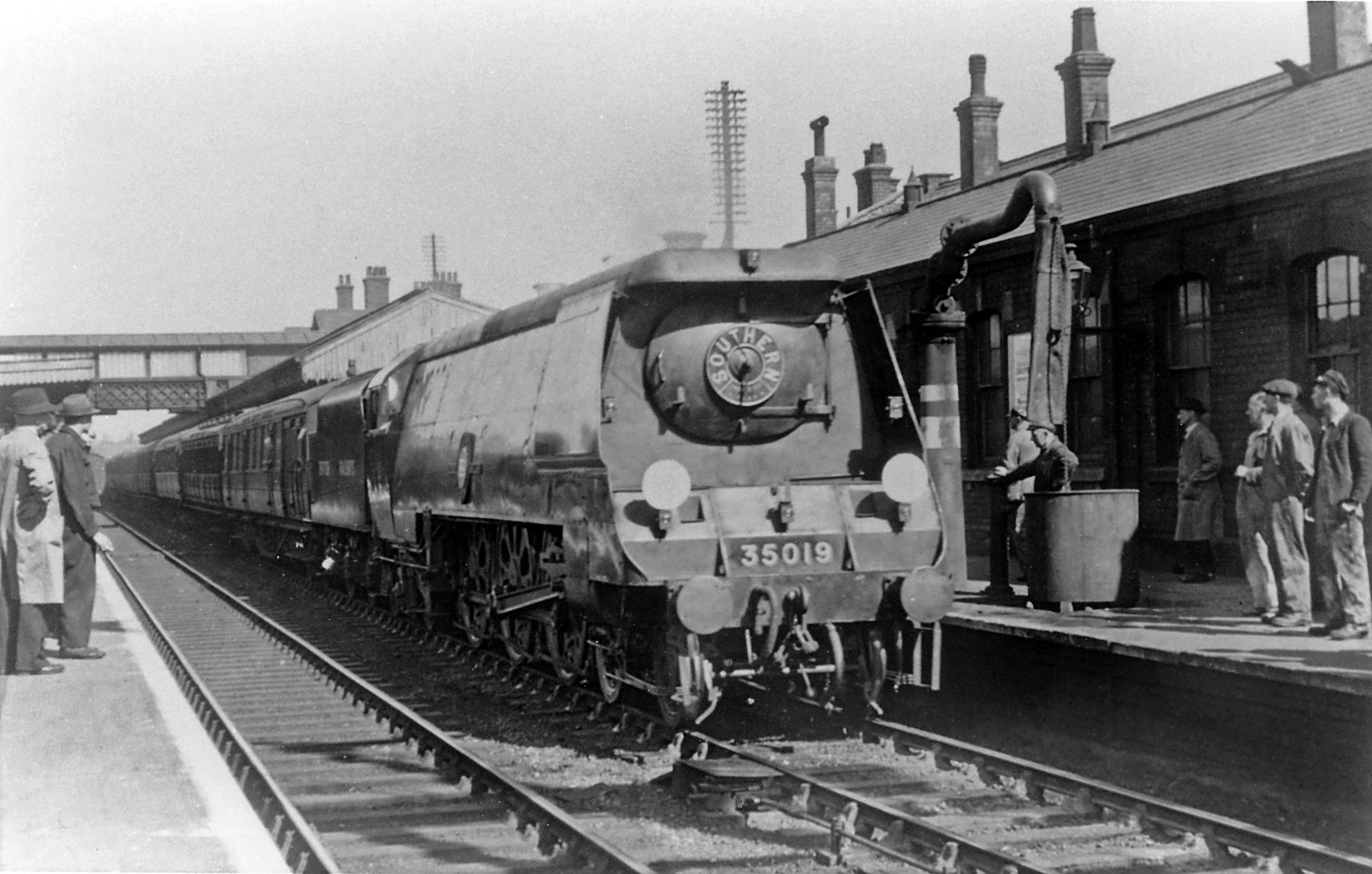 This is a scene that Peter might have witnessed - he could even be one of the bystanders. Railwaymen and other intereted people gather at the south end of the station in the spring of 1948 to inspect No.35019 French Line C.G.T., one of the Southern Region's Merchant Navy express passenger locomotives brought onto the East Coast line during the exchange trials. These locomotives were a big talking point at the time because they embodied some quite revolutionary design features. The 'Merchant Navies' were therefore very different from the Nigel Gresley-inspired express passenger locomotives that would normally head this Leeds to London service. However their chief designer, Oliver Bulleid, began his career as a railway engineer on the Great Northern Railway at Doncaster Works and he had been Gresley's assistant for many years until 1937, when became the Chief Mechanical Engineer of the Southern Railway. So there was a particularly keen interest in seeing how the former GN/LNER man's locomotives would perform on his old East Coast territory. The white bands painted on the water crane at eye level are a reminder of the difficulties of operating the railway under blackout conditions during wartime. Photograph from the J. Scott-Morgan Collection of the Historical Model Railway Society (HMRS).