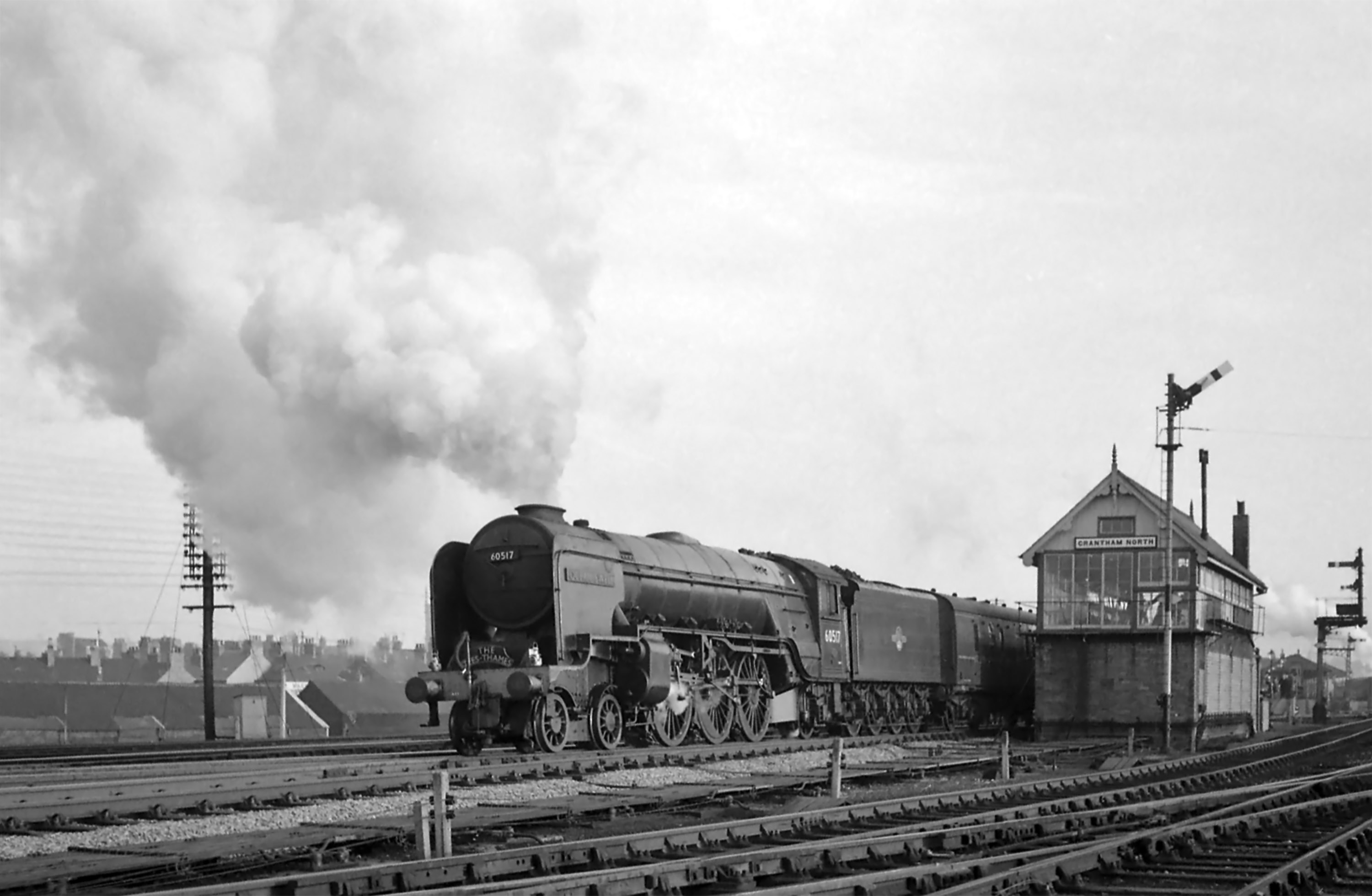 In this picture of the late 1950s or early 1960s we can see how the windows in the base of the box have been bricked up. This was a wartime measure intended to give some protection from air raid damage to signal boxes which had vital strategic importance. No. 60517 Ocean Swell gets away northbound on the Main line, while a train for Nottingham is signalled past the western side of the box. Photograph by Noel Ingram, used with permission from Steam World.