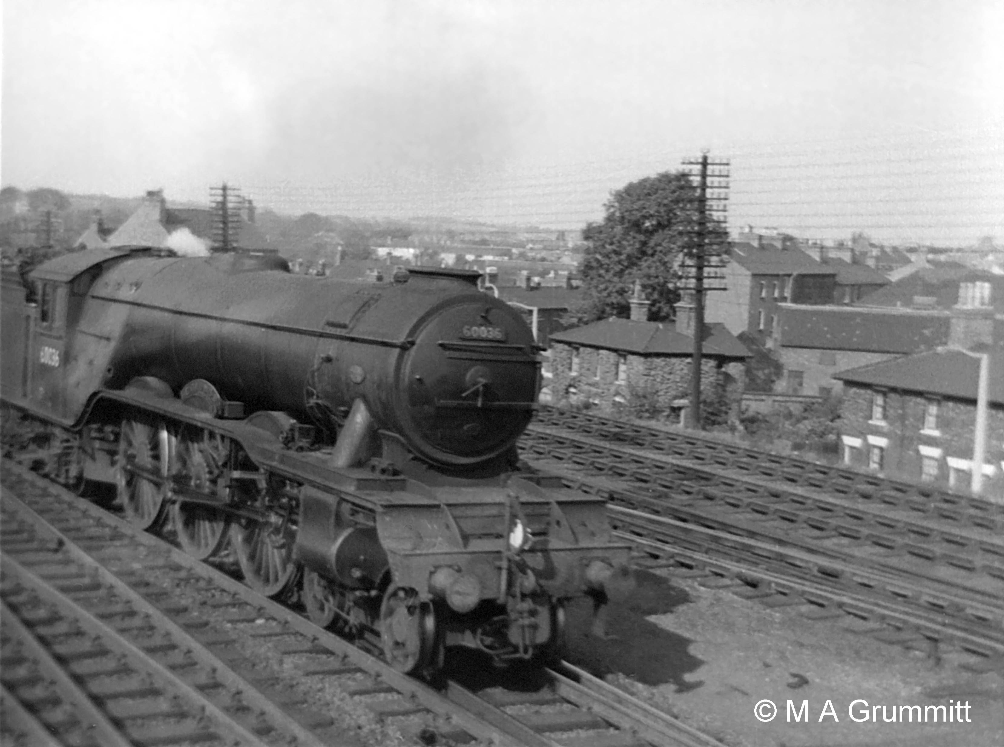 No.60036 Colombo is moving south off the Nottingham line, heading from Grantham shed to New England at Peterborough. It is carrying the headlamp code for a light engine – one lamp at the centre, above the coupling hook. Each locomotive crew was required to have two headlamps aboard as a vital part of their equipment. Here the second lamp would be on the rear of the tender, acting as a tail lamp. It was, and still is, obligatory for every train to show a tail lamp. If a train or a locomotive passes a signal box and there is no tail lamp it will be stopped because it is an indication that the train may have become divided. Photograph by Mick Grummitt.