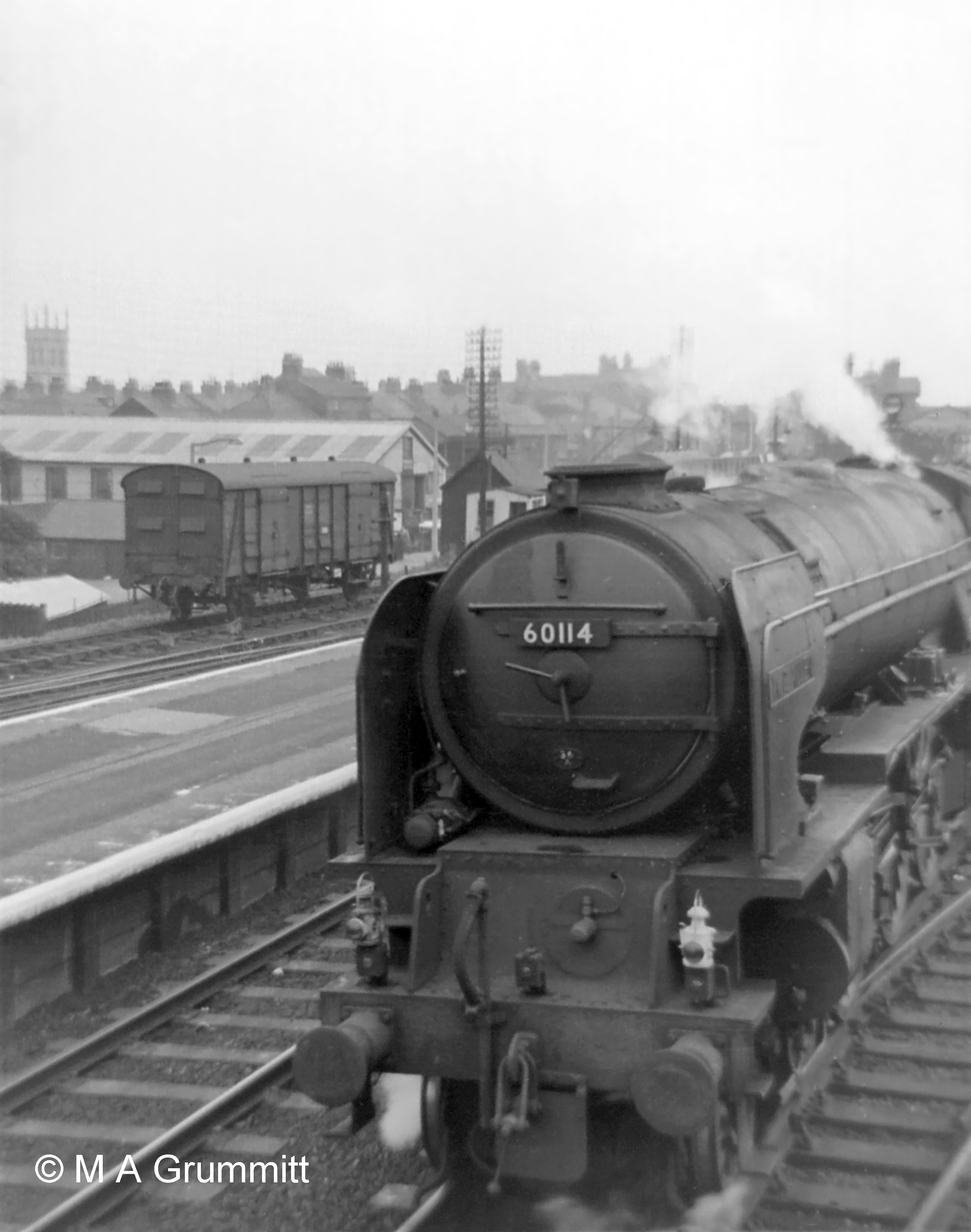 Class A1 No. 60114 W P Allen starts an express for the north. In the siding is a 4-wheeled covered carriage truck (known on the railways as a ‘CCT’), a van equipped with end doors so that a road vehicle could be driven inside from a loading dock. Grantham station had such a facility at the end of this siding, north of the main station building, with access from Station Road. Photograph by Mick Grummitt.