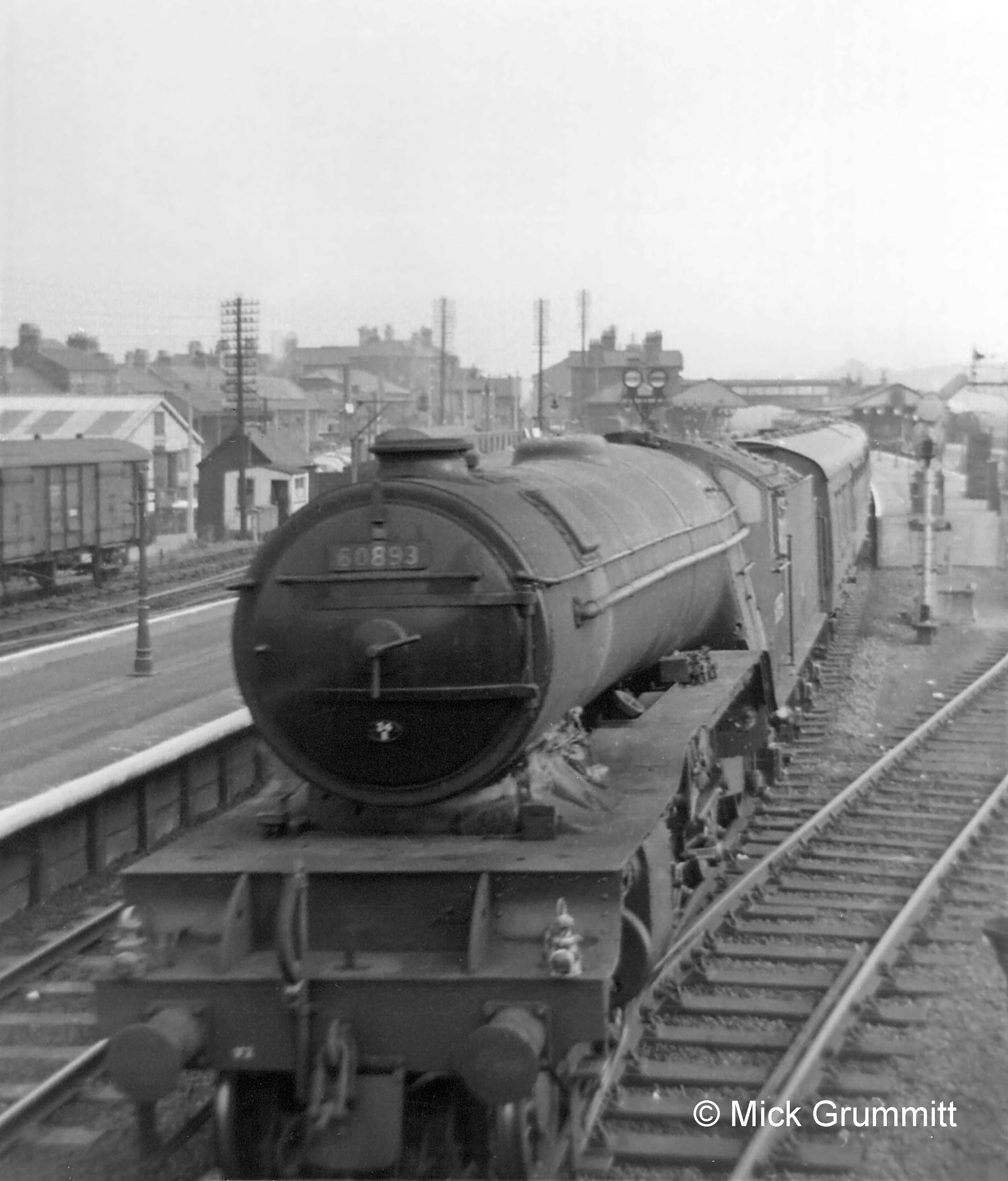  V2 locomotive No.60893 of New England shed, Peterborough, leaves for the north. The two headlamps, one above each buffer, denote an express passenger train. These headlamp codes were an aid to signalmen in identifying trains so they could ensure that the most important traffic was given priority. The white-painted lamp cases were themselves a visible indicator in the daytime. During the hours of darkness they were lit by an oil lamp inside, showing a white light to the front through a glass lens. Photograph by Mick Grummitt.